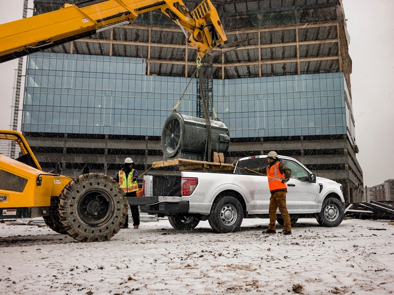 Truck bed of a Ford F-150 Super Duty being loaded at a construction job site to learn about Signs Your Ford Needs Transmission Repair